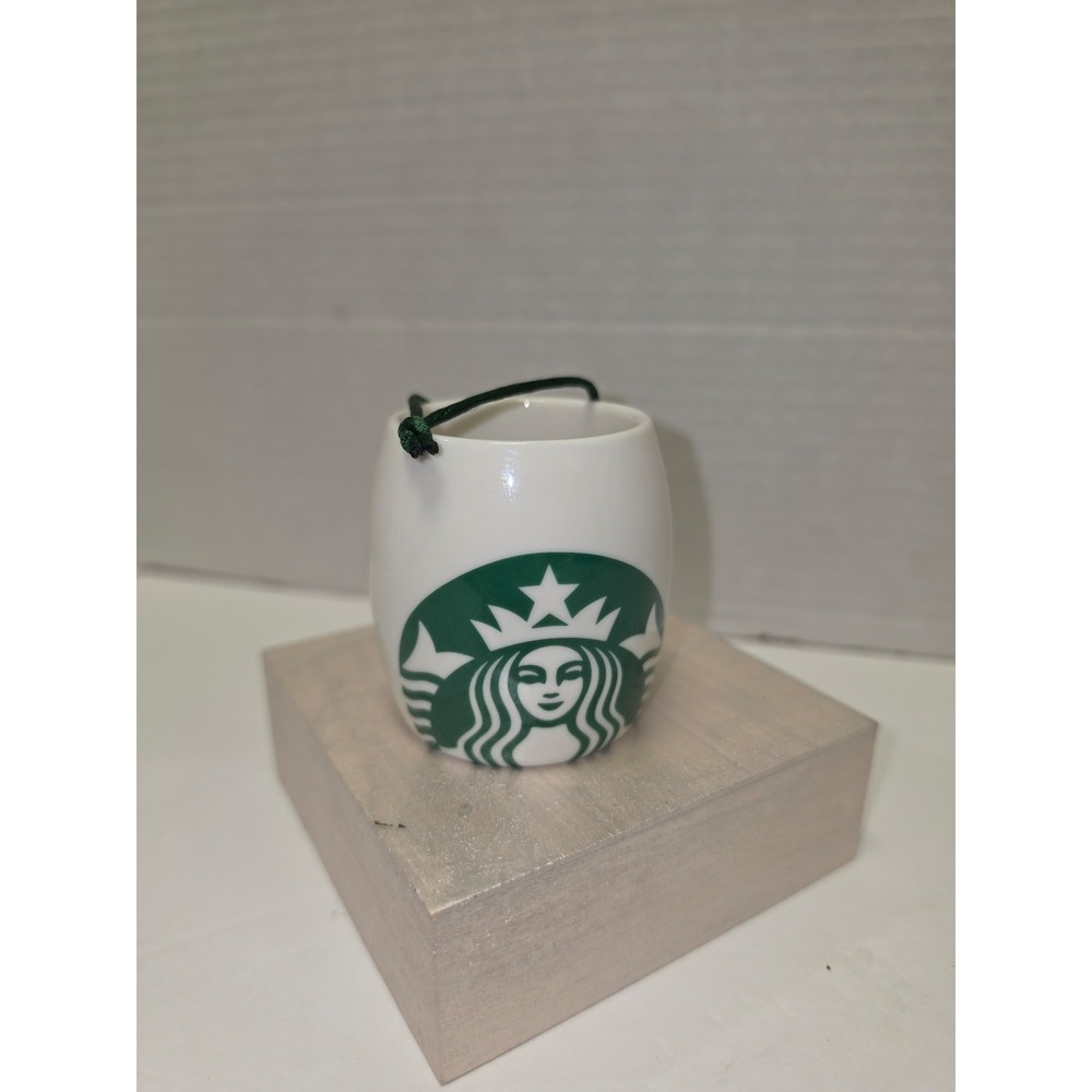 white ceramic Starbucks ornament featuring a green‎ siren logo
